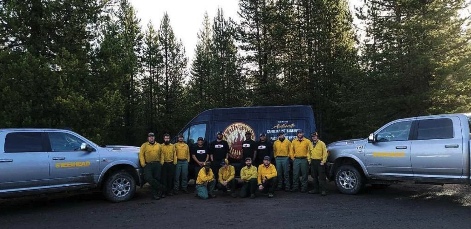 A wildland fire crew with the Philyaw's Cookout catering van at a fire camp in Oregon.
